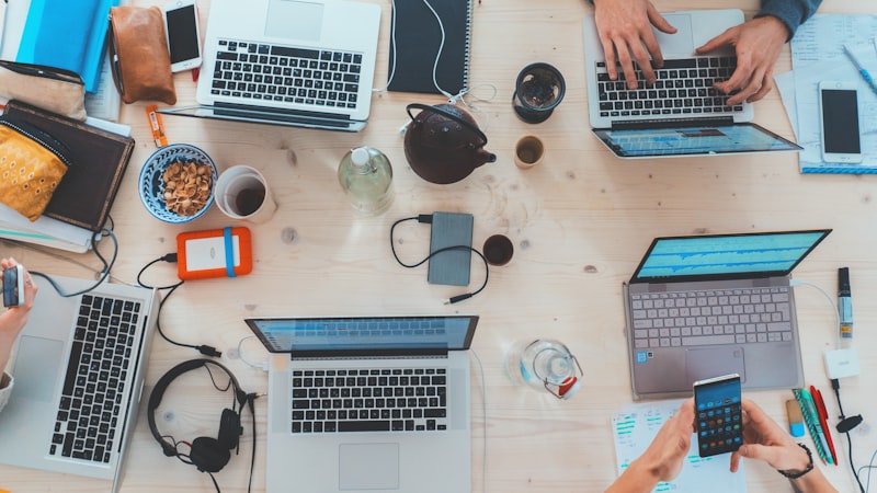 People around a table with laptops in a modern office